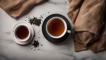 Two Cups of Tea and Tea Leaves on a Marble Surface photo