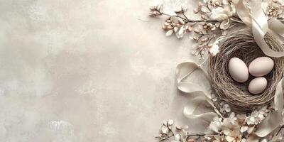 Delicate nest with eggs and cherry blossoms on neutral background for spring decoration photo