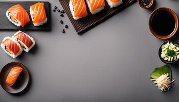 Sushi Rolls on Gray Background with Garnish and Dipping Sauce photo