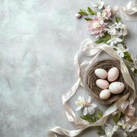 Elegant nest with flowers and egg arranged on a soft surface with ribbon accents photo