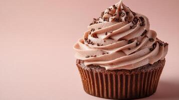 Delicious coffee flavored cupcakes with smooth frosting and chocolate sprinkles on wooden table photo