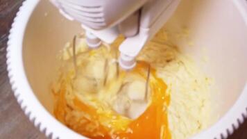 Whipping butter and sugar with egg yolks in slow motion for perfect texture video