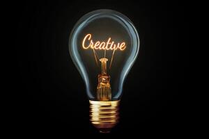 Creative light bulb with a spiral Creative glows on a black background, concept. Thought generator, creative idea. Think differently. Marketing. Growth and learning photo