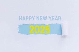 Happy New Year 2025, Creative Idea. White Paper with Torn Label and Year 2025 photo