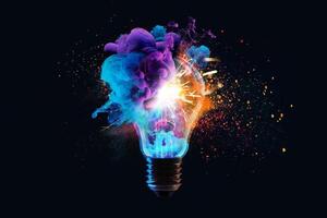 Creative light bulb explodes with colorful dry paint, sparks and splashes on a black background, concept. Think differently creative idea concept. Motion Color drop in water, Ink swirling photo