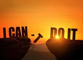 Concept I can't do it and I can do it. I can't the letter t falls into the abyss, creative idea. Two rocks at sunset photo