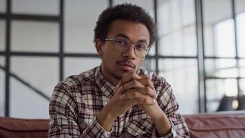Man Sitting Thoughtfully in Modern Office Setting video