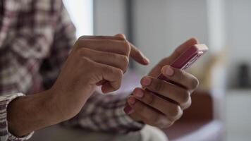 Close-Up of Hands Using Smartphone Indoors video