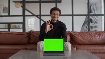Man Showing OK Gesture with Laptop Featuring Green Screen video