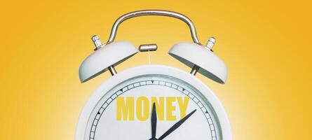 Time for money. White vintage clock pointing to Money on a yellow background photo
