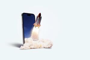 Space rocket takes off from mobile device with smoke, creative idea. Application and optimization, concept. Acceleration and successful startup. Launch photo