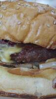A delicious cheeseburger with a sesame bun and various toppings video