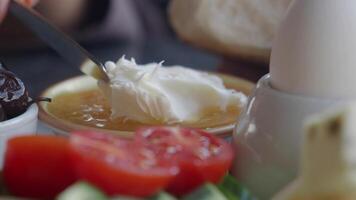 butter cream and honey in a bowl on table . video
