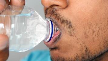 A CloseUp Image of an Individual Consuming Water Directly from a Bottle in a Casual Setting video