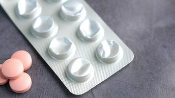 Various Assorted Pills Displayed on a Gray Background for Medical Use video