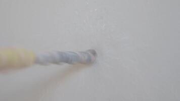 Drill Bit penetrating a Wall during Construction Action, closeup view video