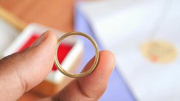 young man hold a wedding ring in a box video