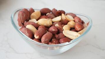 slow motion of dropping Raw Shelled Peanuts in a bowl video