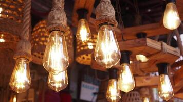 A collection of rustic vintage light bulbs suspended from a wooden structure video