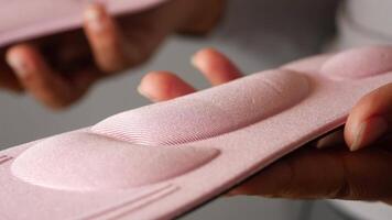 hand holding two shoe insoles showcasing design and texture differences video