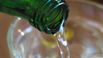 Pouring a Refreshing Beverage into a Glass Filled with Ice Cubes for Enjoyment video