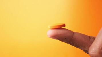 Skillfully balancing a vibrant orange token on a single finger with ease video