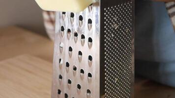 Freshly Grated Cheese Being Prepared with a Grater on a Cutting Board video