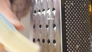 Freshly Grated Cheese Being Prepared with a Grater on a Cutting Board video