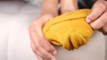 A Cozy Yellow Sock Being Held by a Hand for Added Effect and Style video