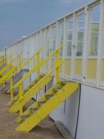 Yellow and white stairs at the beach photo