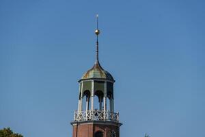 A clock tower with a clock on top in ditzum photo