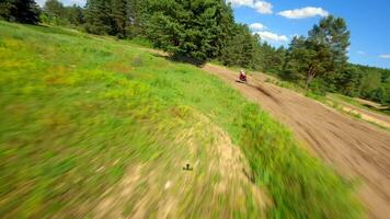 Dynamic FPV shot of a racer on a motocross bike on a track at high speed video