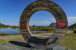 A circular sign with a bench in front of it photo