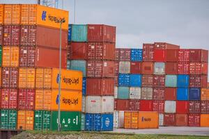 A large stack of shipping containers in the harbor photo