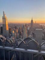 The empire state building is seen in the background photo