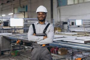 Supervisor posing with crossed arms in a window factory photo