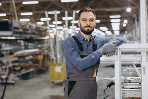 Factory worker posing leaning on a window frame photo