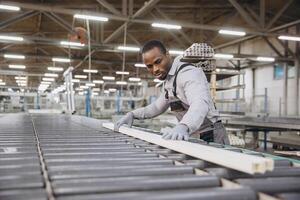 Factory worker checking pvc window frame on production line photo