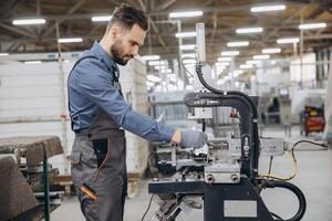 Factory worker operating machinery producing aluminum and pvc windows and doors photo