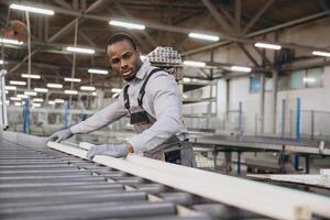 Factory worker handling pvc window frame on production line photo