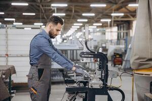 Factory worker operating machinery producing aluminum and pvc windows and doors photo