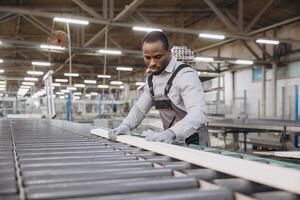 Factory worker checking PVC window frame on production line photo