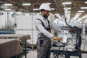 Factory worker operating machinery producing aluminum and pvc windows and doors photo