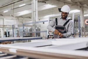 Factory worker assembling aluminum window frames in production line photo