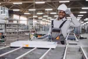 Factory worker assembling aluminum window frame in production line photo