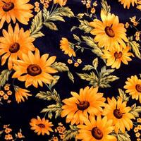 An intricately embroidered tablecloth adorned with a profusion of colorful blooms. photo