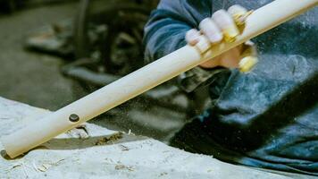 carpenter using nail gun or brad nailer tool on wood box in a workshop ,furniture restoration woodworking concept. selective focus. High quality photo