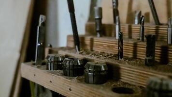Various tools. file, screwdriver, hammer, pliers, garden tools are displayed on wooden shelf inside rustic garage or manufactory, workshop studio in a rustic garden house. Hobby, leasure activity. High quality photo