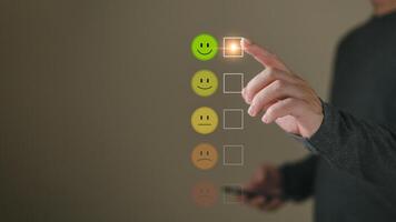 a businessman choose the virtual screen on the happy smile face icon to give satisfaction in service.rating very impressed.customer review service and Satisfaction concept photo