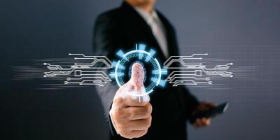 Businessman protecting personal data on finger print with virtual screen interfaces. Cyber security and privacy concepts to protect data. Lock icon and internet network security technology. photo